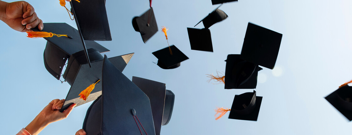 The,Students,Holding,A,Shot,Of,Graduation,Cap,By,Their