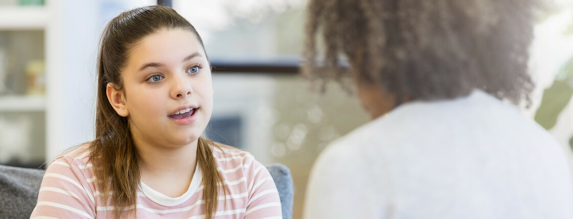 Teenage girl talks to school counselor